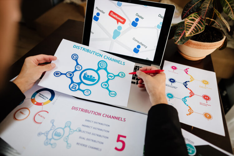 marketing distribution channels plan on office desk. Marketing manager desk with plans and strategy of distributive channels for new product.