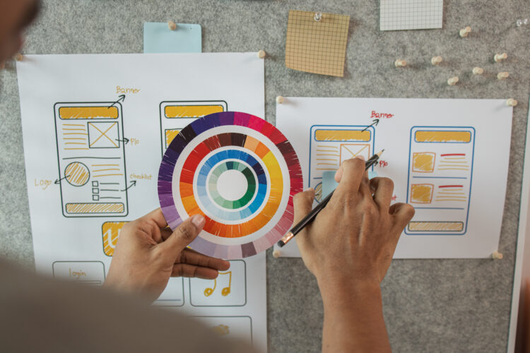 UI UX designers team working on new website wireframe in office, ux developer and ui designer use augmented reality brainstorming about mobile app interface wireframe design on desk at modern office